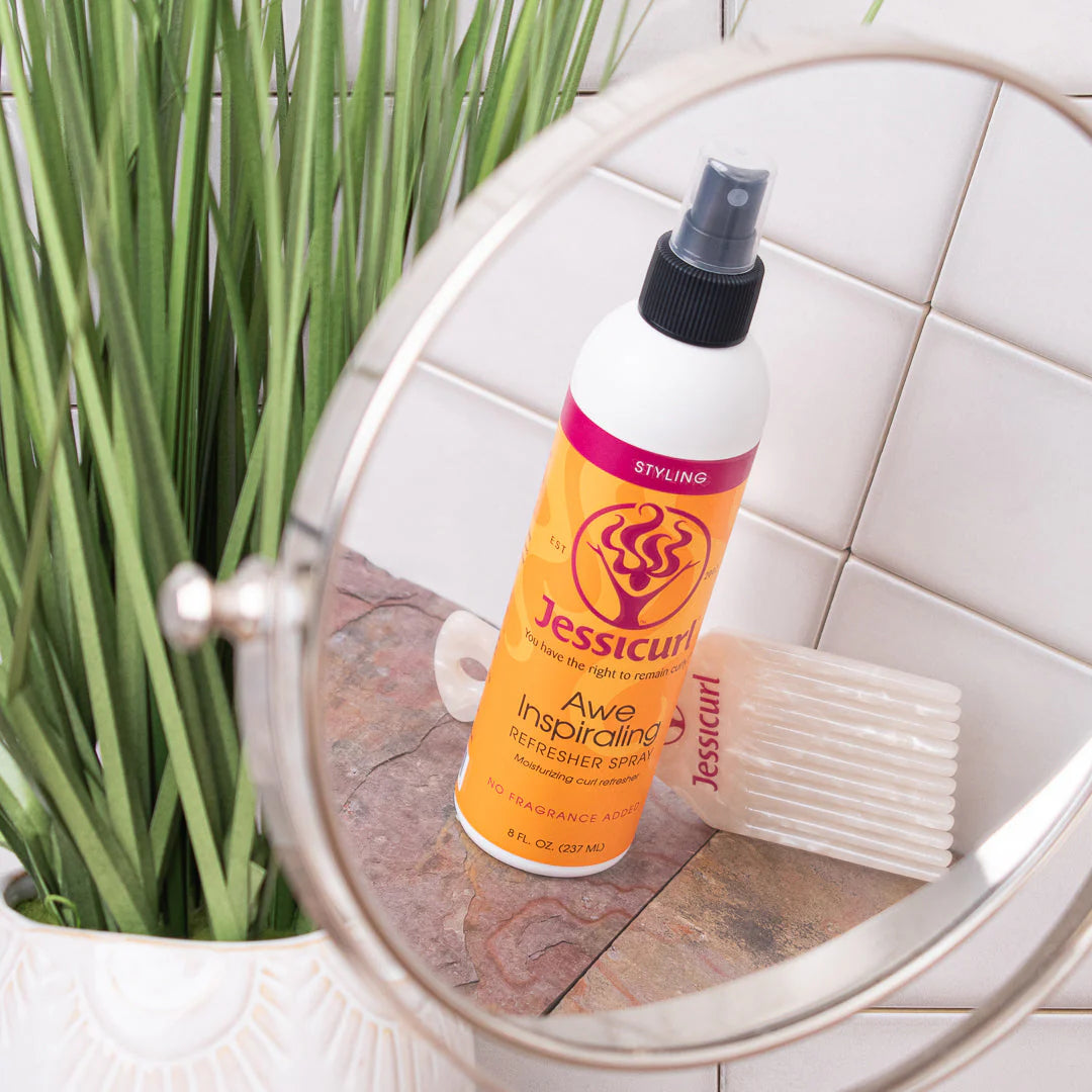 Jessicurl hair product bottle on a bathroom counter with a plant in the background