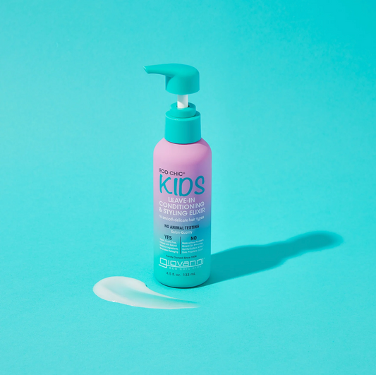 Bottle of Kids Leave-In Conditioning & Styling Elixir on a teal background