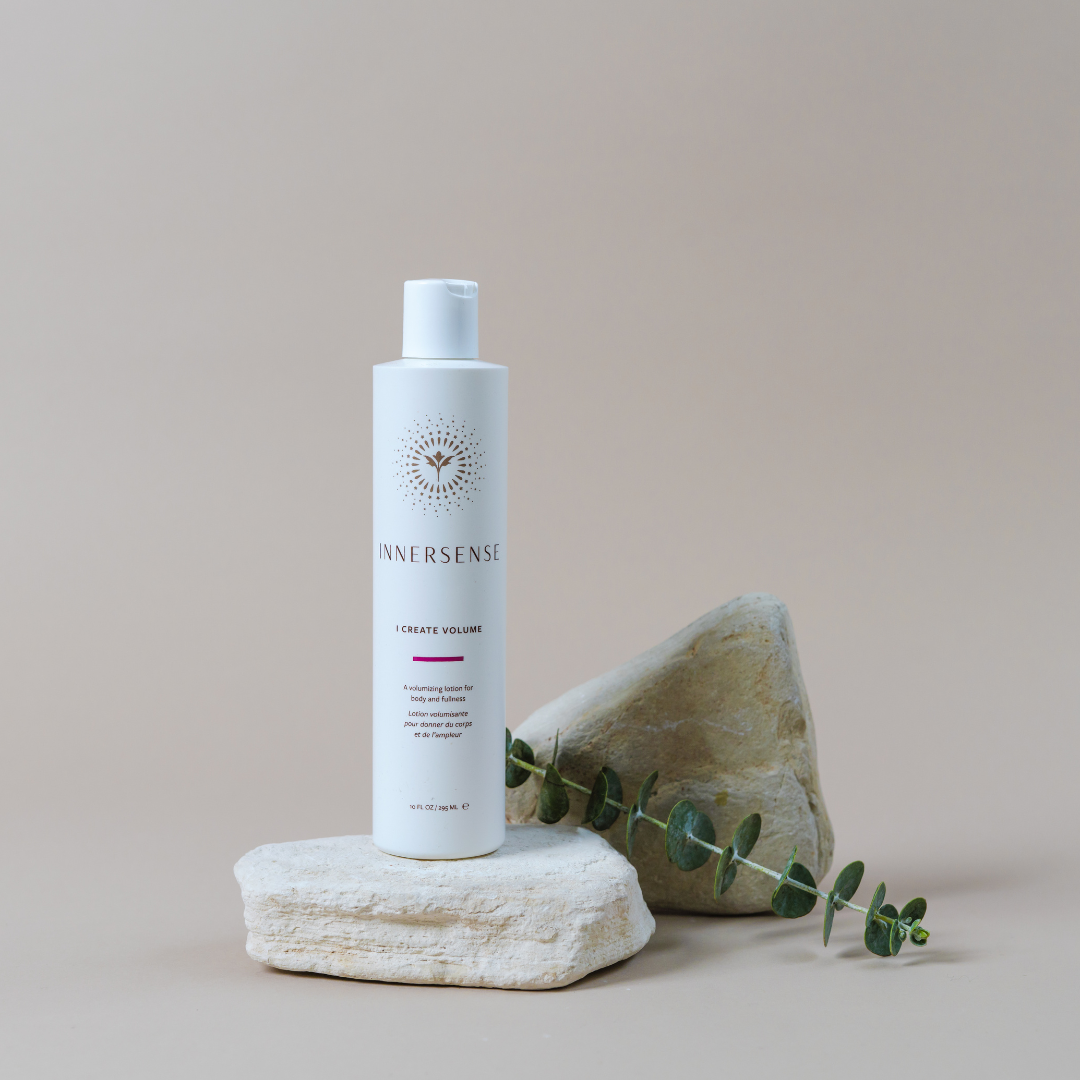 Innersense bottle on a stone surface with a beige background