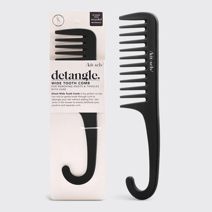 A black Kitsch Wide Tooth Detangle Comb with a no-slip grip, displayed in its packaging which is predominantly white and pink.