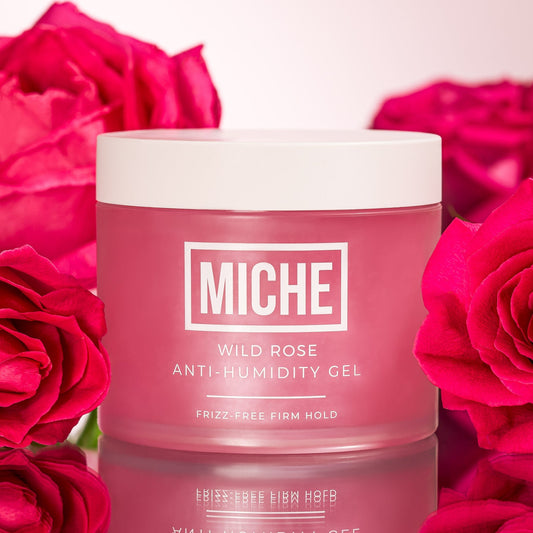Miche Wild Rose Anti-Humidity Gel jar with red roses in the background