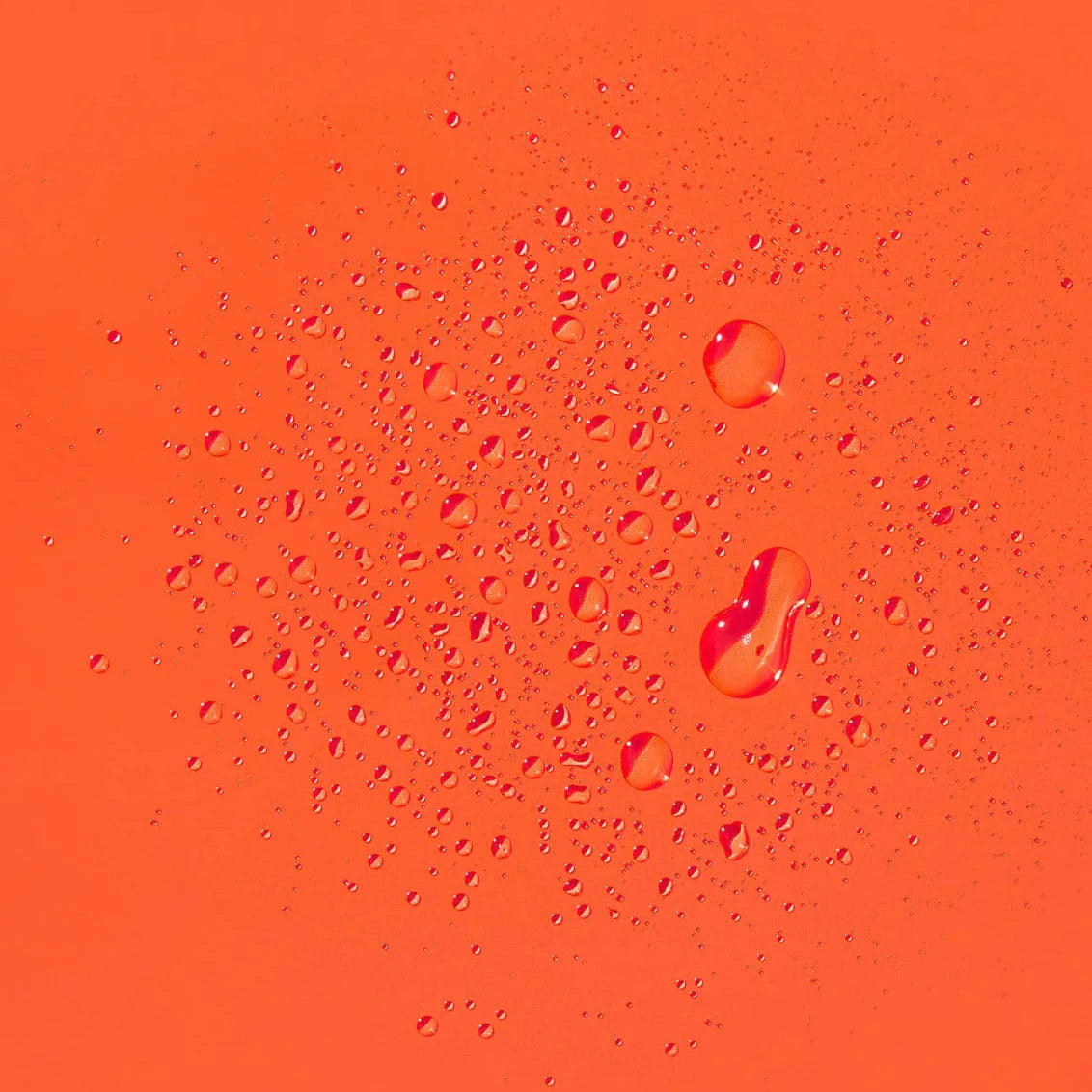 Water droplets on an orange surface