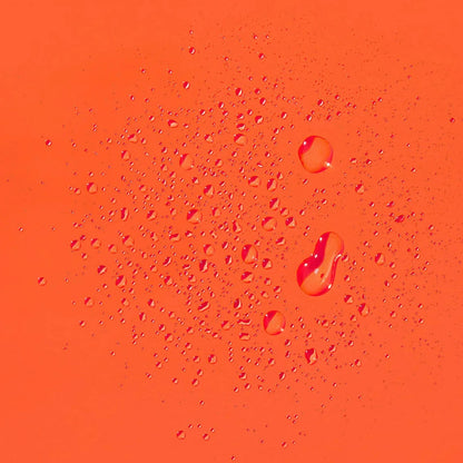 Water droplets on an orange surface