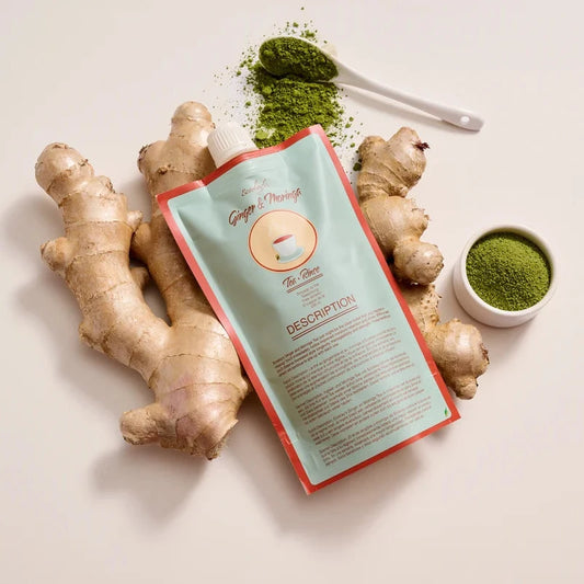 Ginger root and green powder with a package on a light background