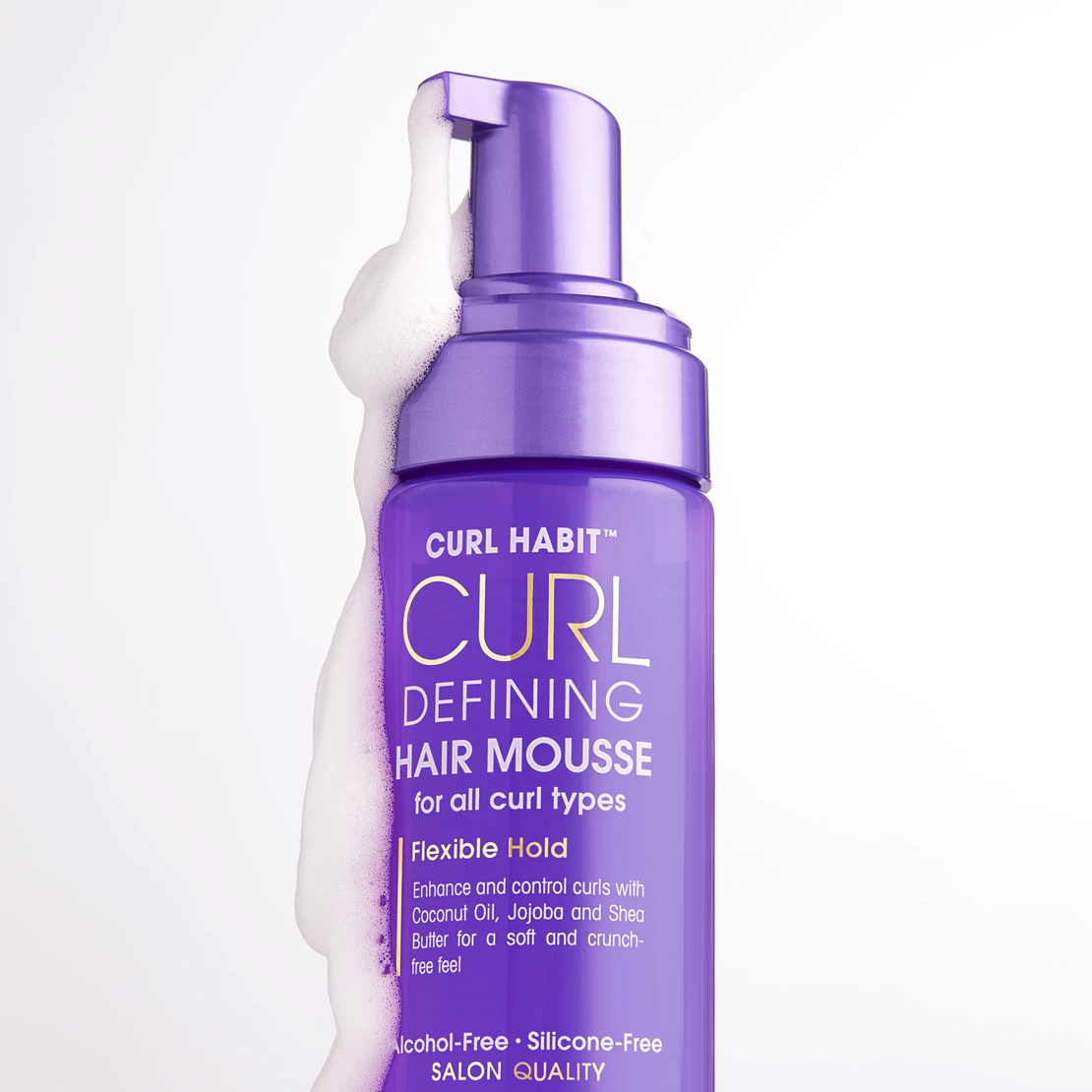 Purple bottle of Curl Habit Curl Defining Hair Mousse on a white background