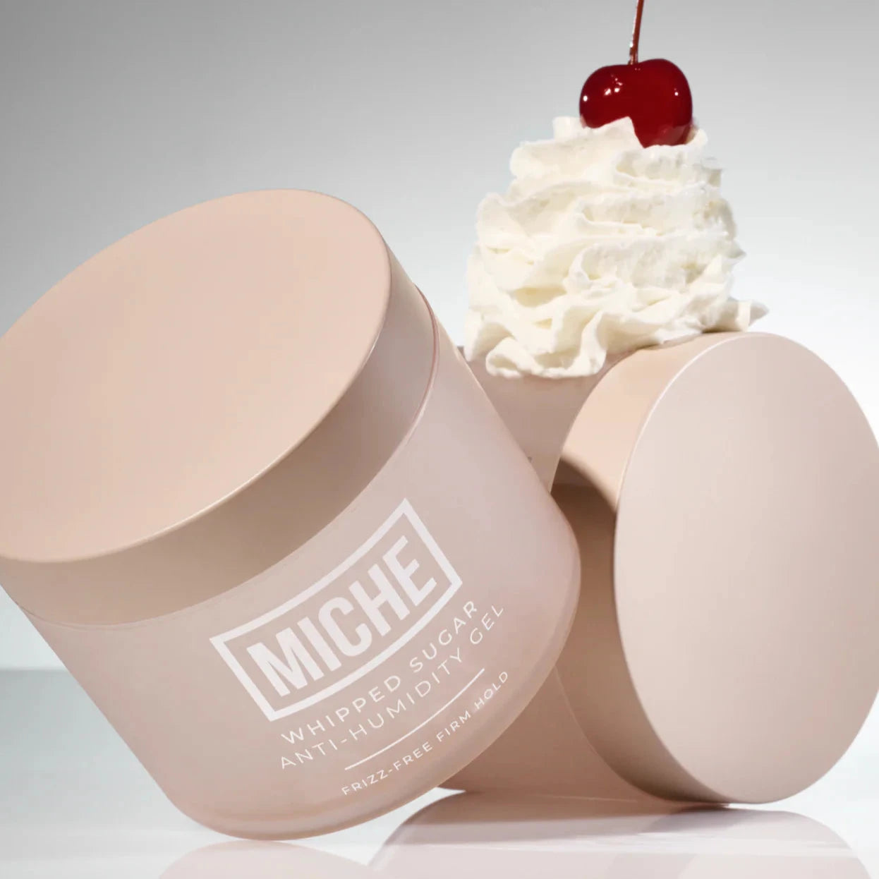 Miche whipped sugar scrub with a cherry on top against a gray background