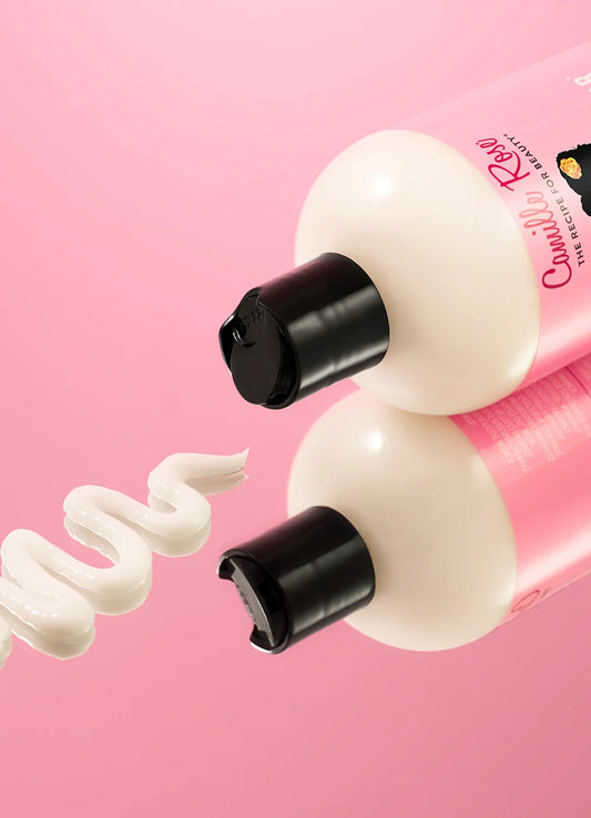 Bottle of cream with a pink background