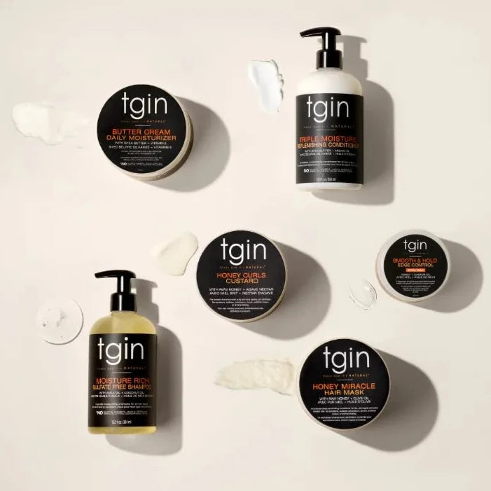 Collection of tgin hair care products on a beige background