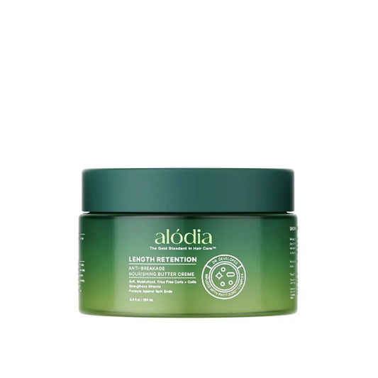 Green jar of alodia hair care product on a white background