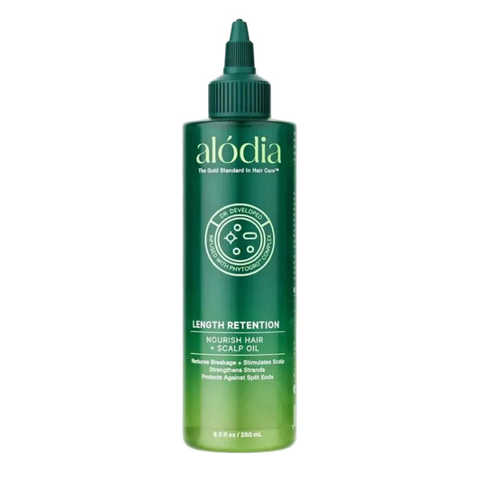 Green bottle of alodia length retention nourish hair and scalp oil on a white background